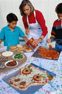 adult and children preparing meal