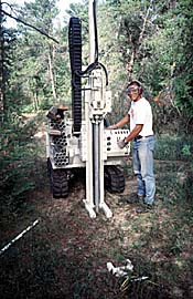 USGS scientist drilling hole for piezometer