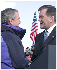 Photo of President Bush and Secretary Ridge shake hands.