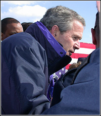 Photo of President Bush greets the audience.