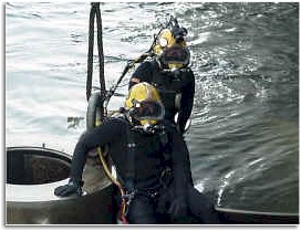 Two divers prepare to enter the water.