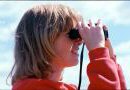 Image of woman searching with binoculars