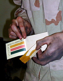 Cpl. Kevin P. Merrill, Nuclear, Biological, Chemical defense specialist for Task Force Kabul, United States Embassy, here, demonstrates how to use M-8 detector paper in an NBC class here, recently.  The paper detects liquid-chemical agents. Photo by: Cpl. Douglass P. Gilhooly