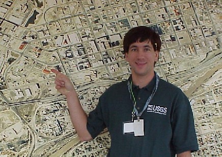 Photograph of Joseph Kerski, GIS course instructor, near an aerial photograph.