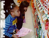 Food Stamp Nutrition Education (FSNE) photo of kids doing an assignment in a grocery store.