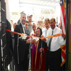 Ambassador cutting ribbon for the inaguration of the e-learning school