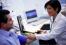 Image of doctor measuring patient's blood pressure