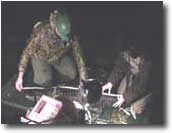 photo of scientists measuring alligator