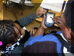 Photo of children using a handheld device as a learning tool.