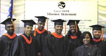 Picture of 7 graduates of the Greenfield Coalition in full regalia on graduation day