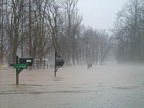Water covering the road creates an impassable barrier.