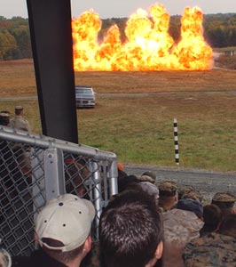 A wall of fire erupts as gasoline and diesel fuel are ignited during an explosives demonstration by the Explosive Ordinace Disposal unit at the Charlie demo range at The Basic School. Photo by: Lawrence Giberson