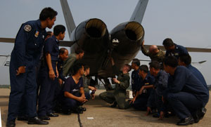 Marines and their Thai counterparts gather around an F/A-18 to learn about the crash, fire, rescue techniques specific to the aircraft. Photo by: Cpl. David Revere
