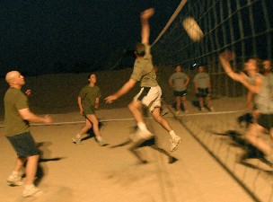 First Lt. Daniel R. Myers, reconnaissance and surveillance coordinator, Command Element, 11th Marine Expeditionary Unit (Special Operations Capable), spikes the ball during a volleyball tournament here, Oct. 19. The MEU commanding officer's Personal Security Detail took first place, the Army's 153rd Engineers took second and the MEU S-4 team took third. Photo by: Gunnery Sgt. Chago Zapata