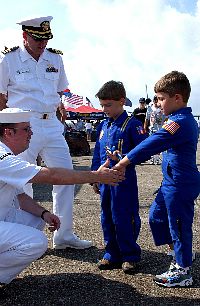 Journalist 1st Class Robert Kerns and Cdr. Jack Hanzlik talk with young visitors during the New Orleans Air Show.