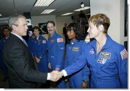 President George W. Bush greets shuttle astronauts from right, Peggy Whitson, Stephanie Wilson, and John Grunsfeld, and Ellen Ochoa at NASA headquarters in Washington, D.C., Wednesday, Jan. 14, 2004. The President committed the United States to a long-term human and robotic program to explore the solar system, starting with a return to the Moon that will ultimately enable future exploration of Mars and other destinations. White House photo by Eric Draper.