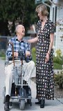 old man in wheelchair with woman