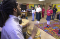 Jay Coleman's music class practices their African dance steps.