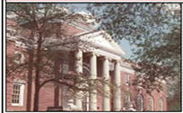 A stereotypical main campus building -- large, red brick, white columns