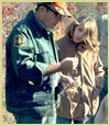 Photo of a  Forest Service employee helping a vacationer.
