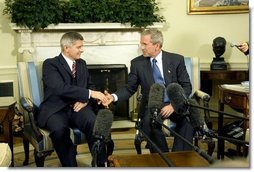 President George W. Bush and Prime Minister Marek Belka of Poland meet with the press in the Oval Office Monday, Aug. 9, 2004. White House photo by Eric Draper.