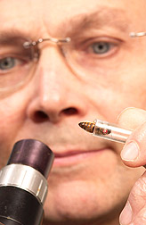 Photo: Entomologist John Harbo prepares a queen bee for artificial insemination. Link to photo information