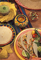 A Mexican meal featuring tacos made with soft white flour tortillas. Link to photo information