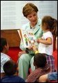 Laura Bush reads the book "That's My Dog" to students from the Clayton Center, a migrant Head Start Program, at the Raleigh Durham Airport in Raleigh, N.C. Friday, July 18, 2003. Mrs. Bush presented each child a book to help encourage reading and school readiness. White House photo by Tina Hager.