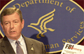 Attorney General John Ashcroft holding FBI Advisory document