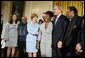 President George W. Bush and Mrs. Laura Bush pose with jazz musicians after a performance to honor Black Music Month in the East Room of the White House on June 22, 2004. White House photo by Paul Morse.