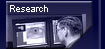 Research Rollover Button. Image shows man having his retina scanned.