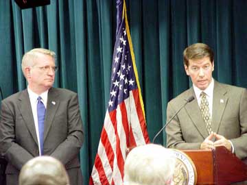 Photo of John Walters and Dr. Runge at press conference as decribed below