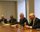 Secretary Powell sits at conference table with newspaper editors