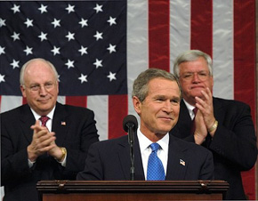 President George W. Bush reacts to applause while delivering the State of the Union address at the U.S. Capitol, Tuesday, Jan. 28, 2003. Also pictured are Vice President Dick Cheney, left, and Speaker of the House Dennis Hastert.