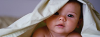 Photo of infant under blanket