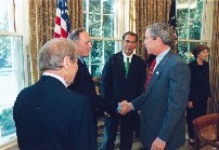 President Bush congratulates Congressman Hoekstra after signing his Museum and Libraries Services Act of 2003 in the Oval Office.