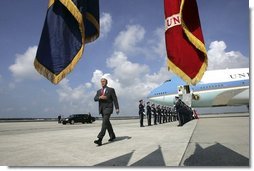  President George W. Bush walks past a military honor guard after arriving aboard Air Force One at MacDill Air Force Base in Tampa, Florida, Wednesday, June 16, 2004. White House photo by Eric Draper.