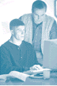 Photo of Caucasian father and son at a computer