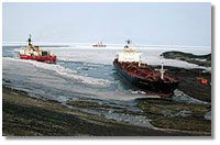 the icebreakers guide the tanker Gus C. Darnell