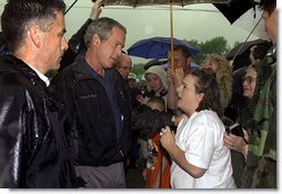 Listening to the story of how a tornado swept through their town, President George W. Bush meets one-on-one with residents during his walking tour of Pierce City, Mo., Tuesday, May 13, 2003. White House photo by Susan Sterner.