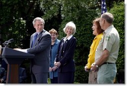 President George W. Bush discusses his plan for wildfire prevention and forest stewardship, the Healthy Forests Initiative, in The East Garden Tuesday, May 20, 2003. Standing on stage with the President are, from left, Agriculture Secretary Veneman, Interior Secretary Gale Norton, Fire Management Officer Andrea Gilham and Wildlife and Fire Staff Officer Rex Mann. White House photo by Susan Sterner.