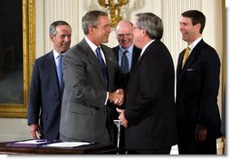 President George W. Bush shakes the hand of Congressman Bill Thomas, R-Calif., after signing the Jobs and Growth Tax Reconciliation Act of 2003 in the East Room Wednesday, May 28, 2003. Also pictured are, from left, Secretary of Commerce Donald Evans, Secretary of the Treasury John Snow and Senate Majority Leader Bill Frist, R-Tenn. White House photo by Eric Draper.