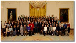 The President and group of teachers in the East Room of the White House