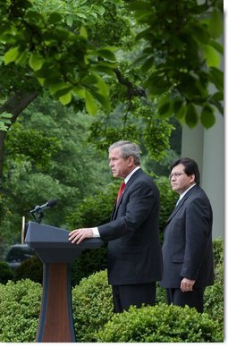 As Counsel Judge Alberto Gonzales stands by his side, President George W. Bush delivers remarks regarding his judicial nominations in the Rose Garden Friday, May 9, 2003. White House photo by Tina Hager.