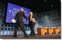 Vice President Dick Cheney greets professor Klaus Schwab, founder and president of the World Economic Forum, before addressing more than 1,000 attendees at World Economic Forum in Davos, Switzerland Jan. 24, 2004. During his speech, Vice President Cheney said international cooperation is required to win the war on terror. "We must meet the dangers together. Cooperation among our governments, and effective international institutions, are even more important today than they have been in the past." White House photo by David Bohrer.