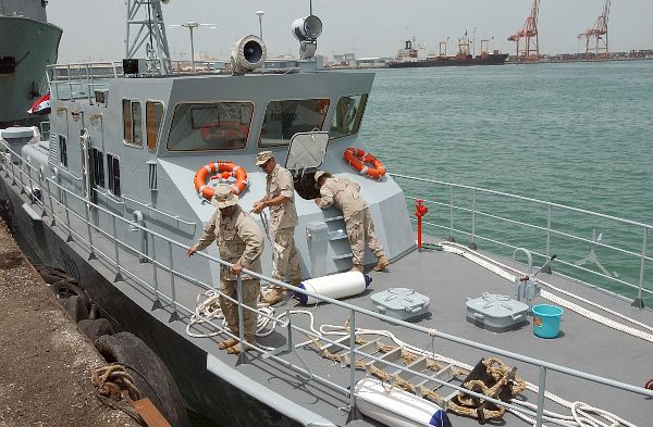 Crewmembers aboard Iraqi Coastal Defense Force (ICDF) Patrol Craft 102 prepare several handling lines.