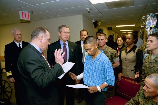 President George W. Bush attends the U.S. Citizenship Ceremony for Marine Corps Lance Cpl. O.J. Santamaria of Daly City, Calif., at the National Naval Medical Center in Bethesda, Md., Friday, April 11, 2003. White House photo by Eric Draper.