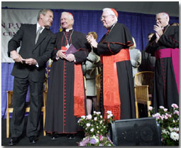 President Bush speaks with (left to right) Cardinals Maida, Law and Keeler at the dedication of the Pope John Paul II Cultural Center in Washington March 22, 2001.