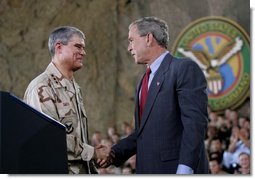 President George W. Bush greets Lieutenant General Lance Smith, Commander Central Command, before delivering remarks to military personnel at MacDill Air Force Base in Tampa, Florida, Wednesday, June 16, 2004.  White House photo by Eric Draper.