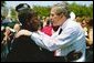 President George W. Bush talks with a woman attending the Annual Peace Officers' Memorial Service at the U.S. Capitol in Washington, D.C., Saturday, May 15, 2004. White House photo by Paul Morse.